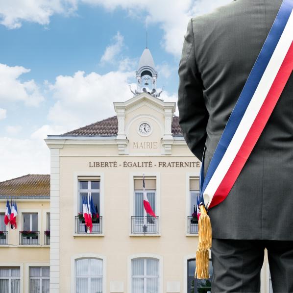 photo d'un maire devant sa mairie