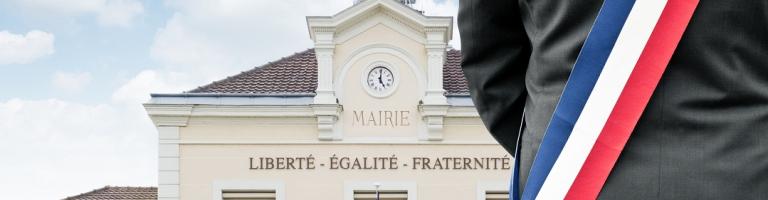 photo d'un maire devant sa mairie